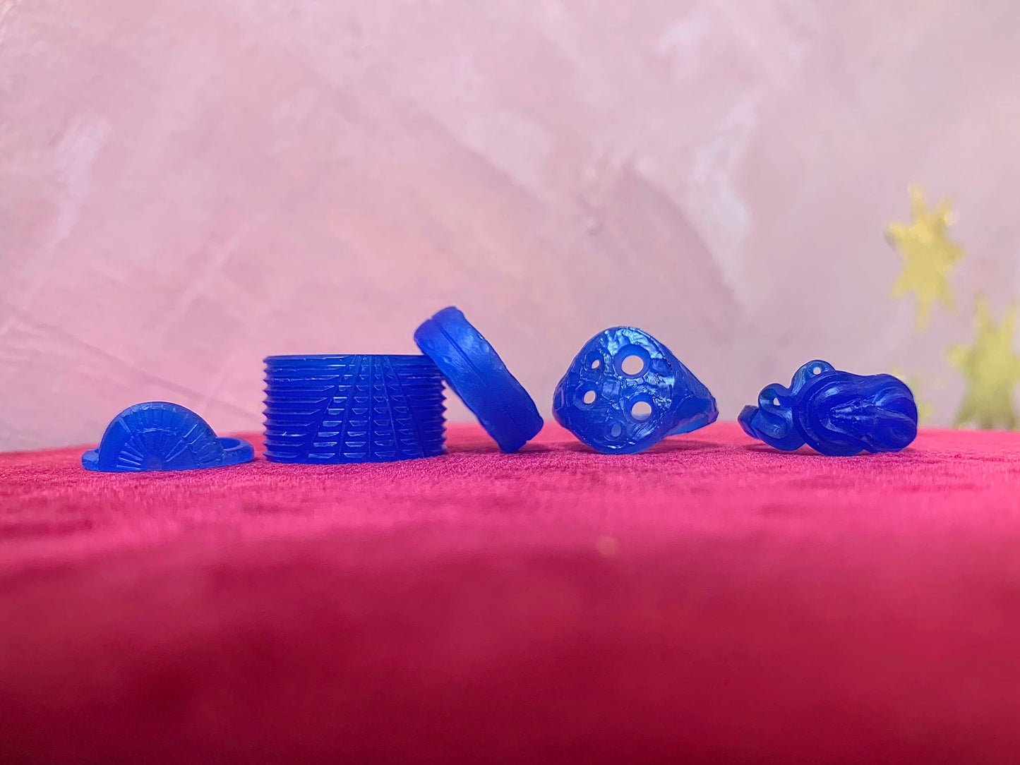 blue wax carvings on pink background