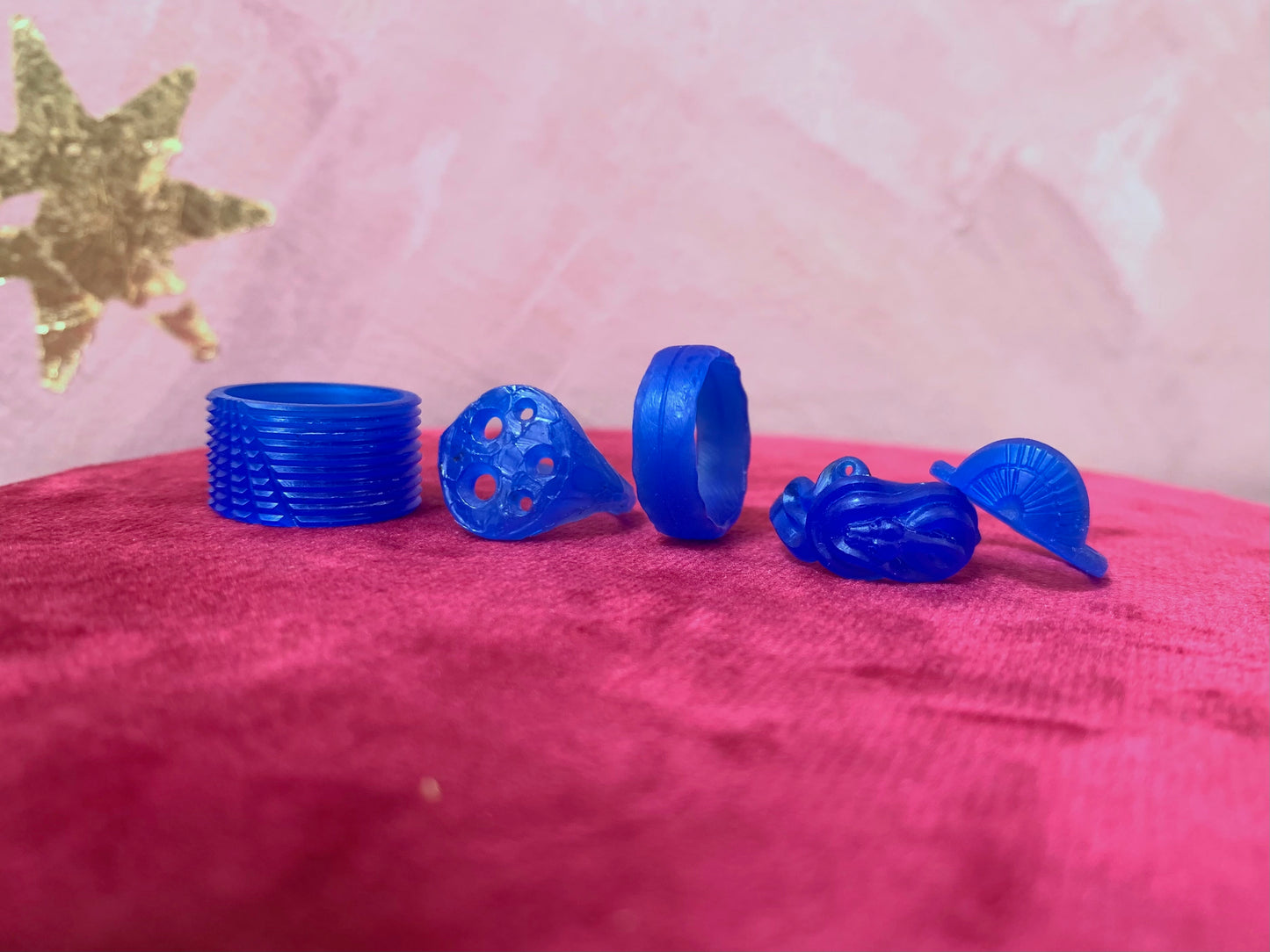 blue wax carvings on pink background