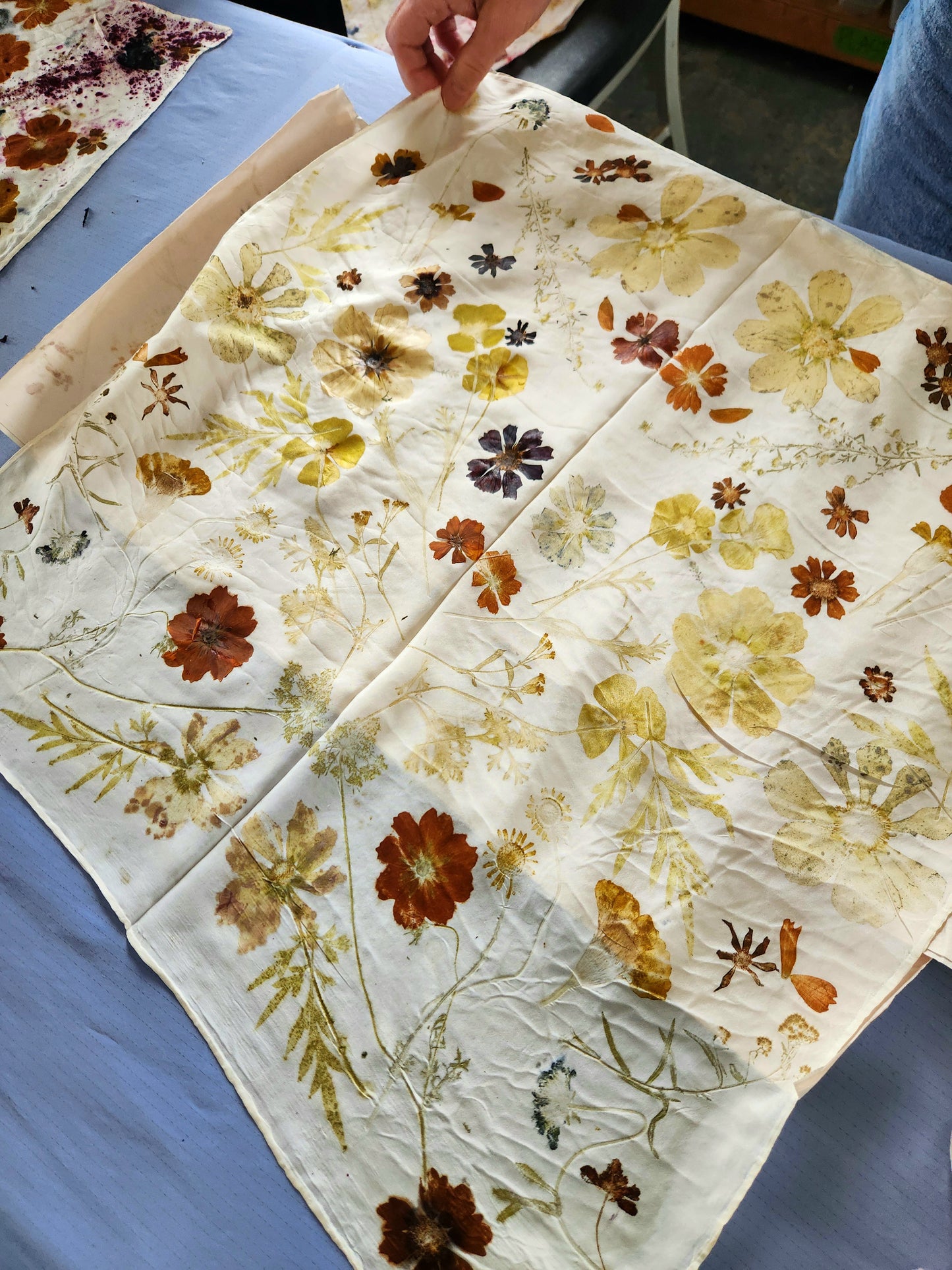 Eco printing and woggle workshop scene showing participants creating natural-dyed prints and woven woggles at Alloy Atelier workshop.