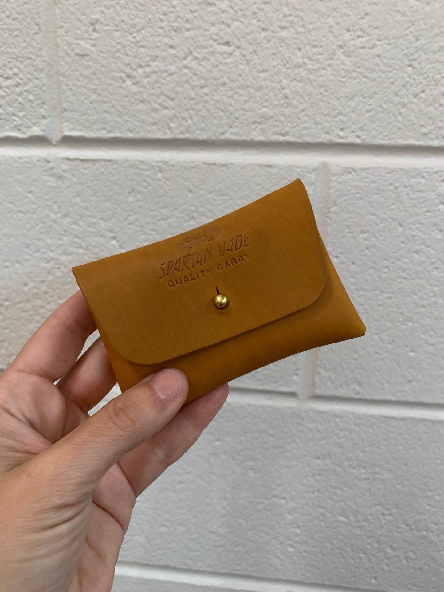 Spartan Made wallet with multiple card slots and a sleek leather design, shown in a close-up image.