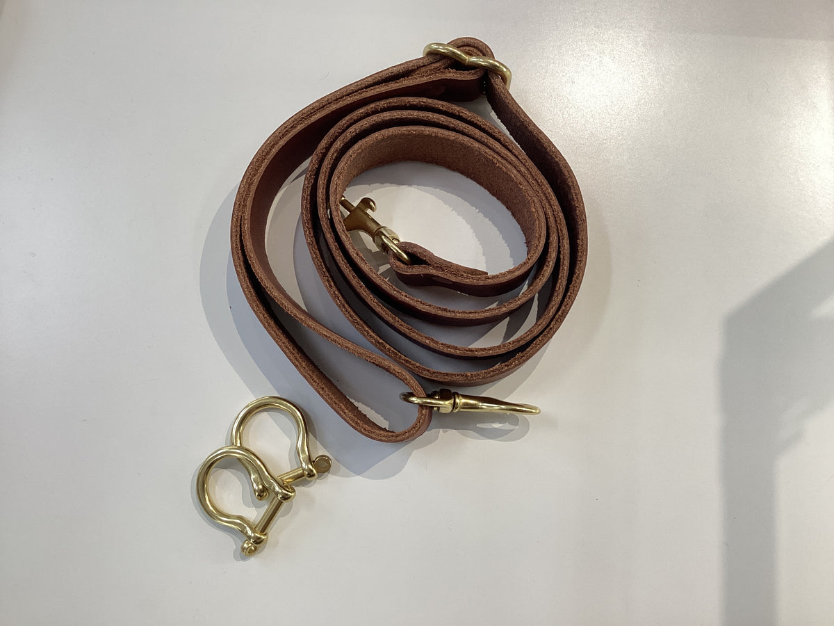 Spartan Made mini tote crossbody strap with shackles, adjustable black leather strap for versatile carrying options.