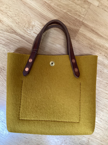 Felt mini tote bag from Spartan Made with a sleek, compact design and sturdy handles for everyday use.