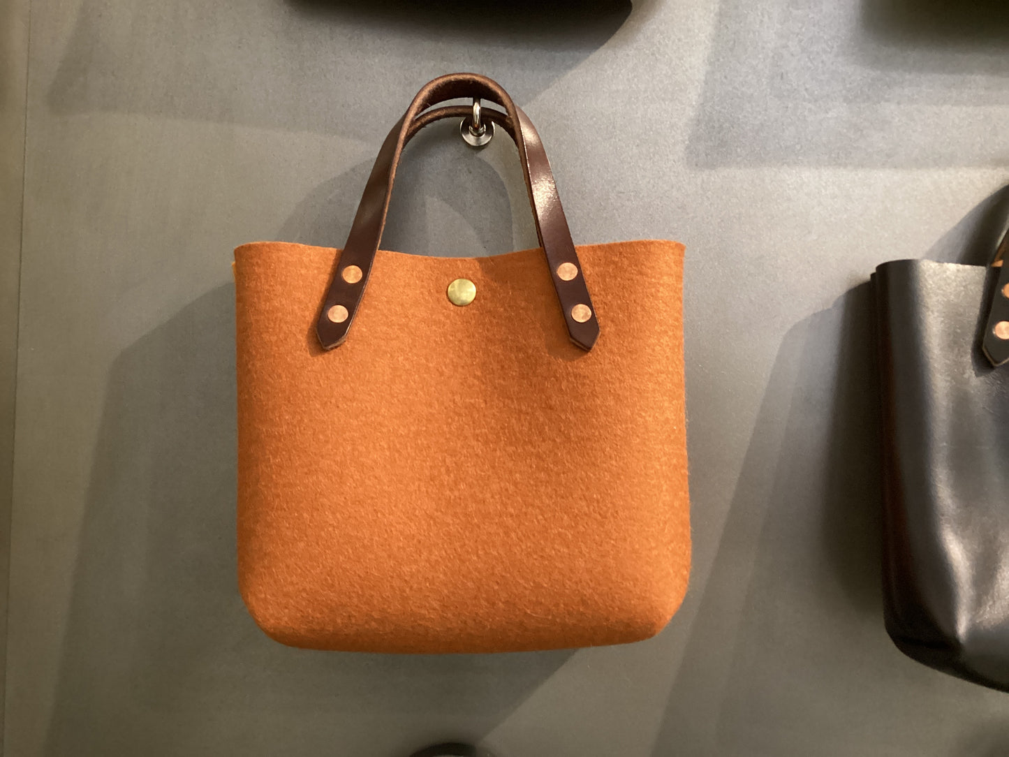 Two-tone felt mini tote bag by Spartan Made featuring a sleek, compact design with sturdy handles and modern style.