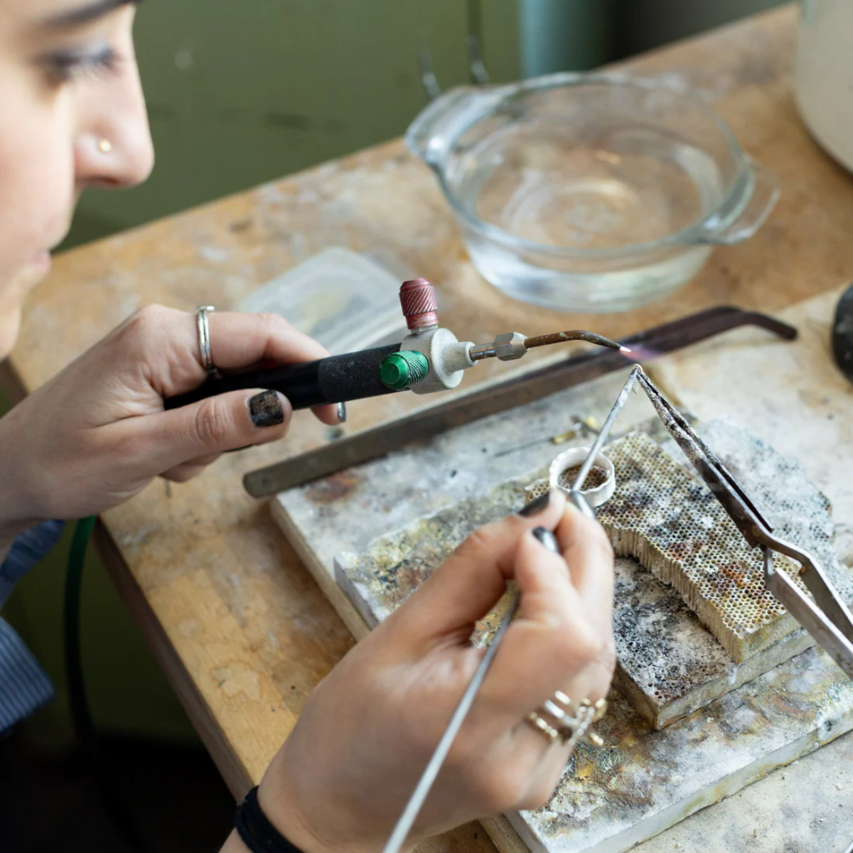 Image of a jewelry class brochure from Alloy Atelier, showcasing various jewelry designs and learning materials.