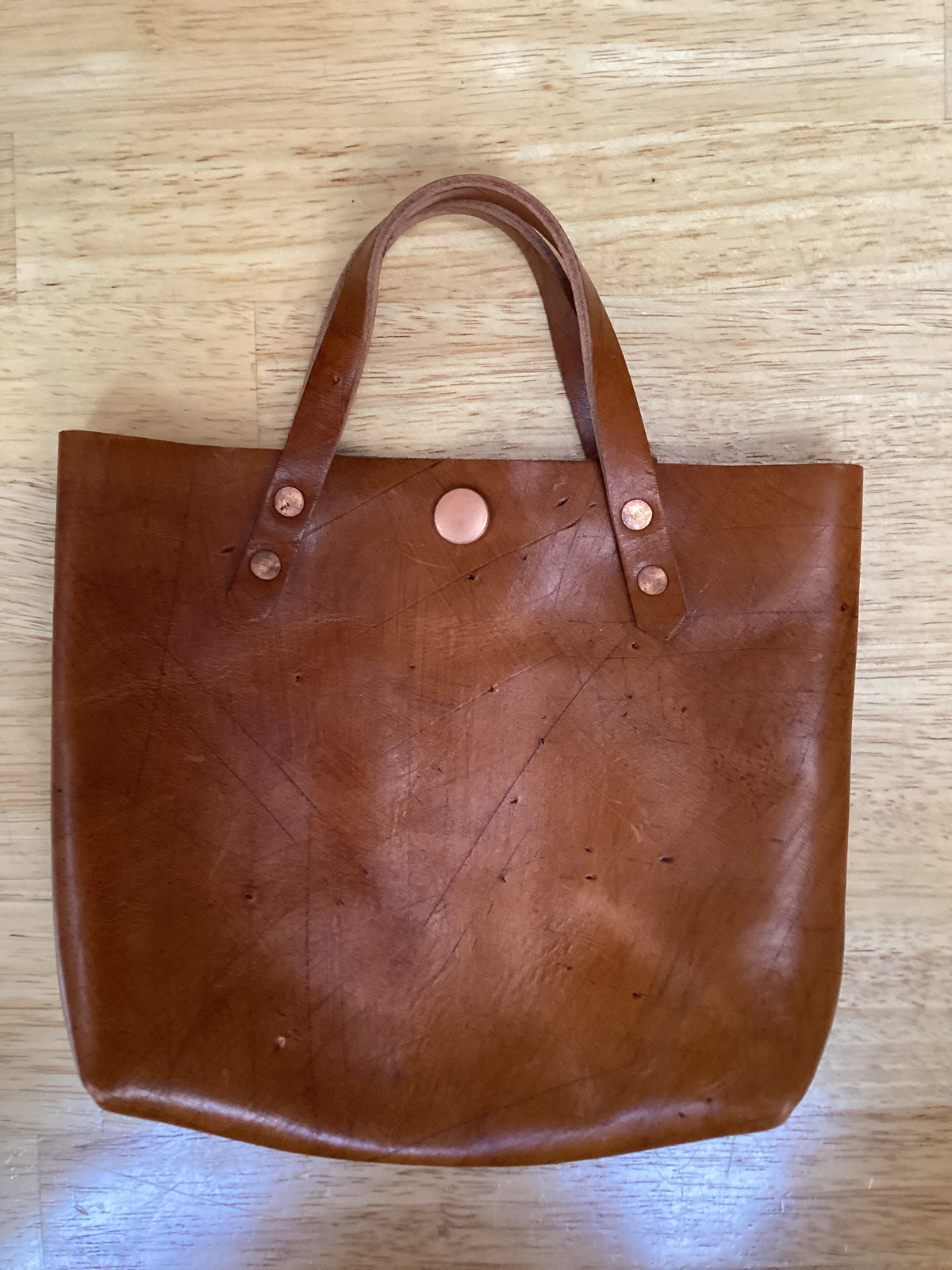 Spartan Made mini leather tote bag with sleek design, featuring sturdy handles and compact size for everyday use.