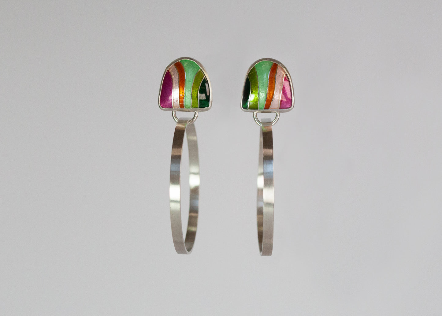 Pink and green flat metal hoops from Echo Metals, stylish Loopy Hoops jewelry with a modern design.