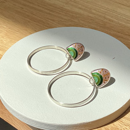 Echo Metals Loopy Hoops earrings with large, circular design, shiny metal finish, and intricate detailing.