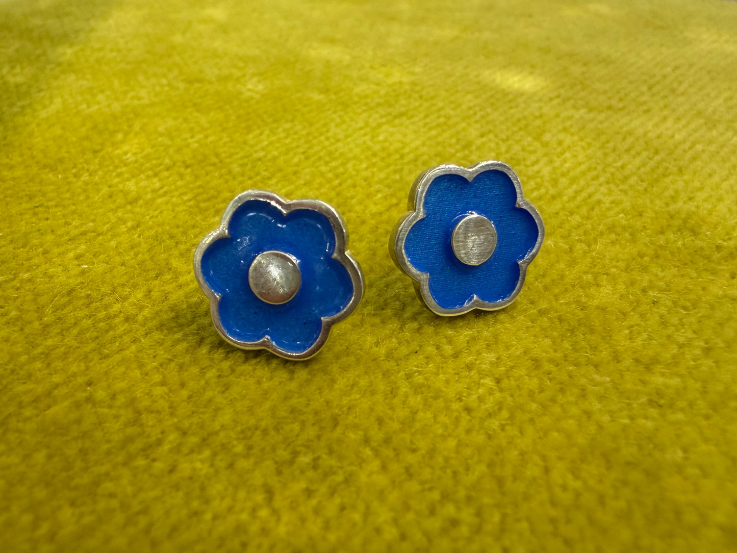 Ellyse Bendillo large flower stud earrings featuring detailed petal designs and silver-tone finish, close-up view.