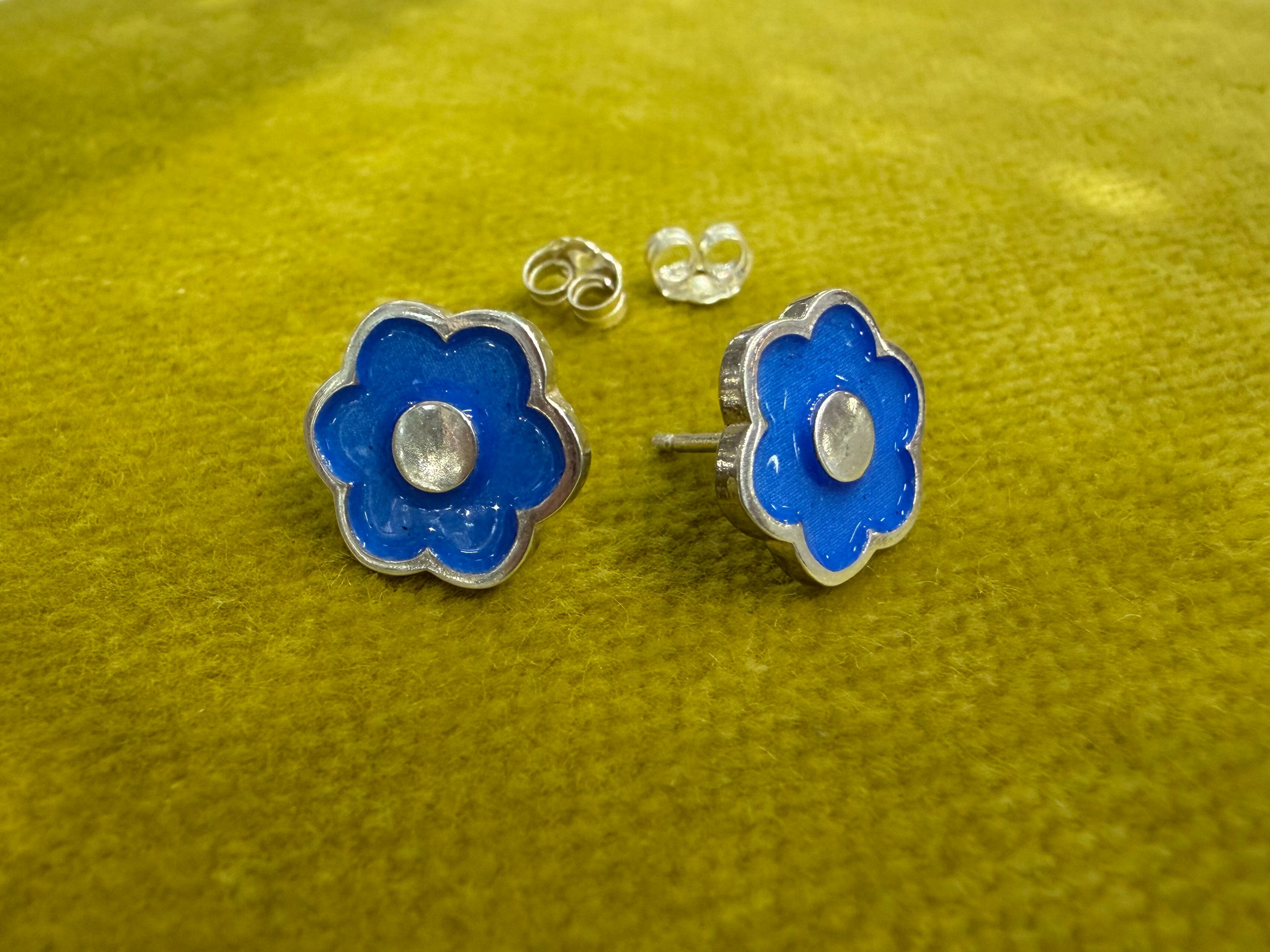 Ellyse Bendillo large flower stud earrings featuring detailed floral design on gold-tone metal.