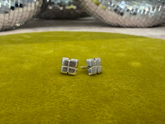 Ellyse Bendillo wedge studs earrings featuring sleek metal design and pointed wedge shape, close-up of jewelry against a neutral background.