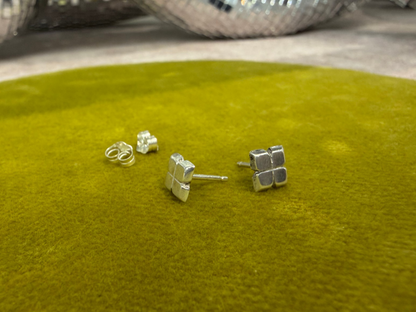 Ellyse Bendillo wedge stud earrings featuring a sleek metallic design and small wedge accents.
