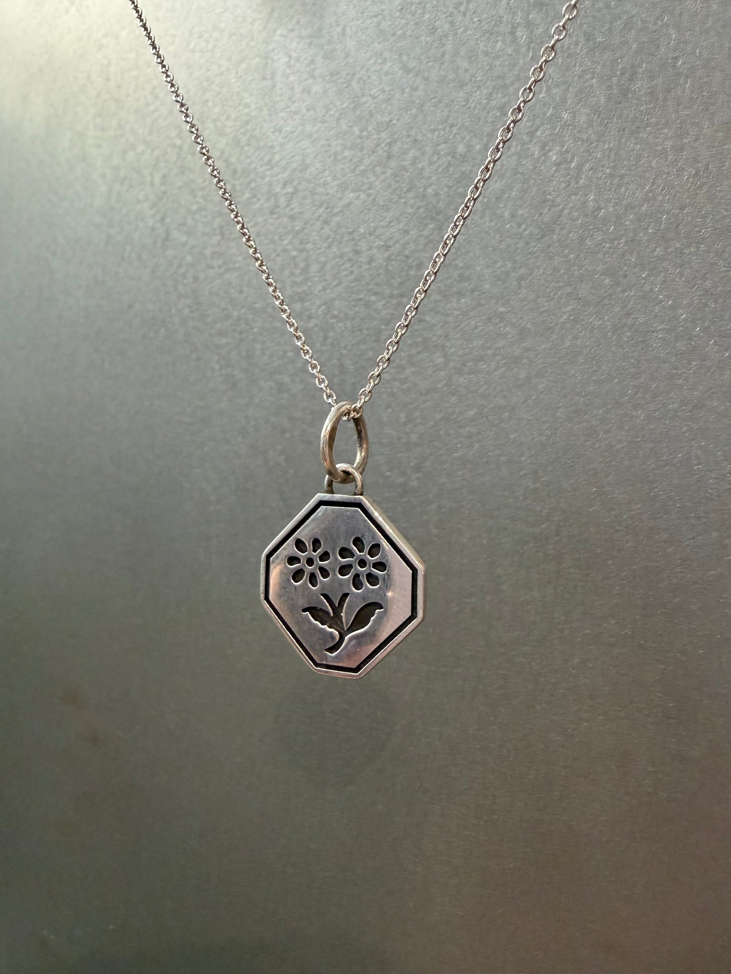 Ellyse Bendillo Floral Duet Charm featuring delicate flower designs on a silver charm for jewelry accessories