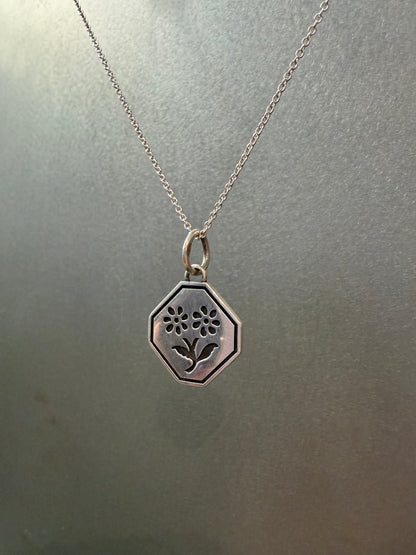 Ellyse Bendillo Floral Duet Charm featuring delicate flower designs on a silver charm for jewelry accessories