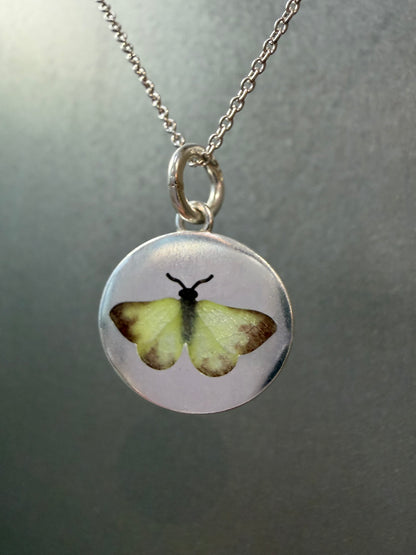 Yellow butterfly charm by Ellyse Bendillo, close-up of detailed metal charm with vibrant yellow wings, ideal for jewelry or craft projects.