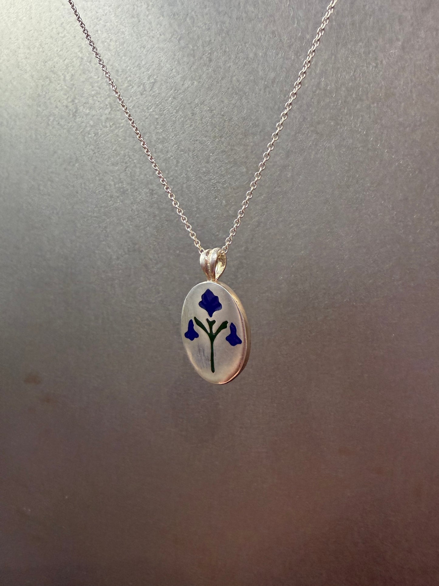 Painted House Lily pendant necklace by Ellyse Bendillo featuring a delicate floral design on a silver chain.