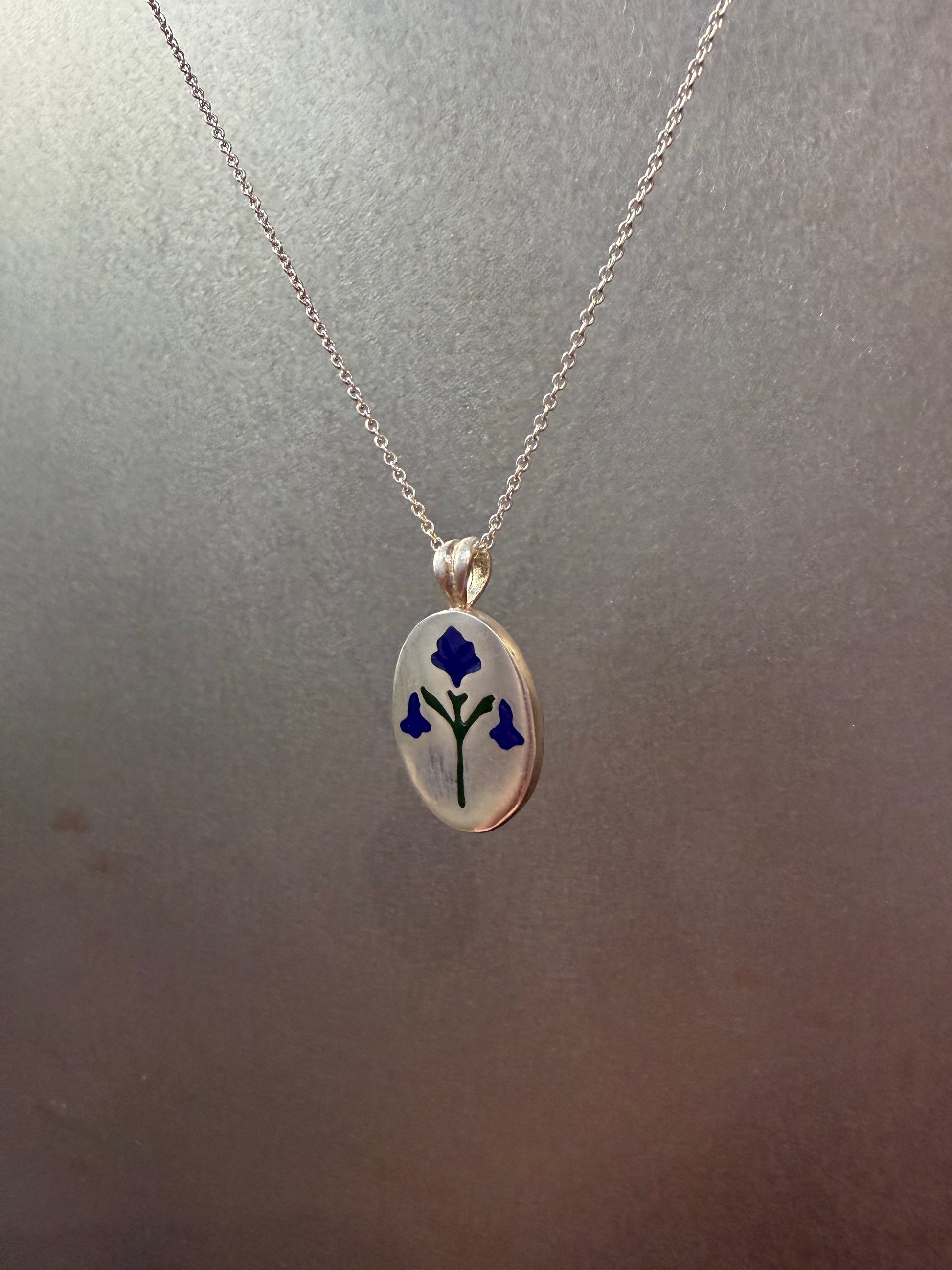 Painted House Lily pendant necklace by Ellyse Bendillo featuring a delicate floral design on a silver chain.