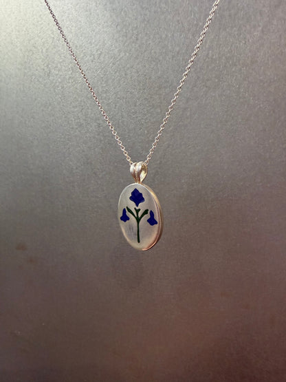Painted House Lily pendant necklace by Ellyse Bendillo featuring a delicate floral design on a silver chain.