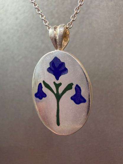 Painted House Lily pendant necklace by Ellyse Bendillo featuring a delicate floral design on a silver chain.