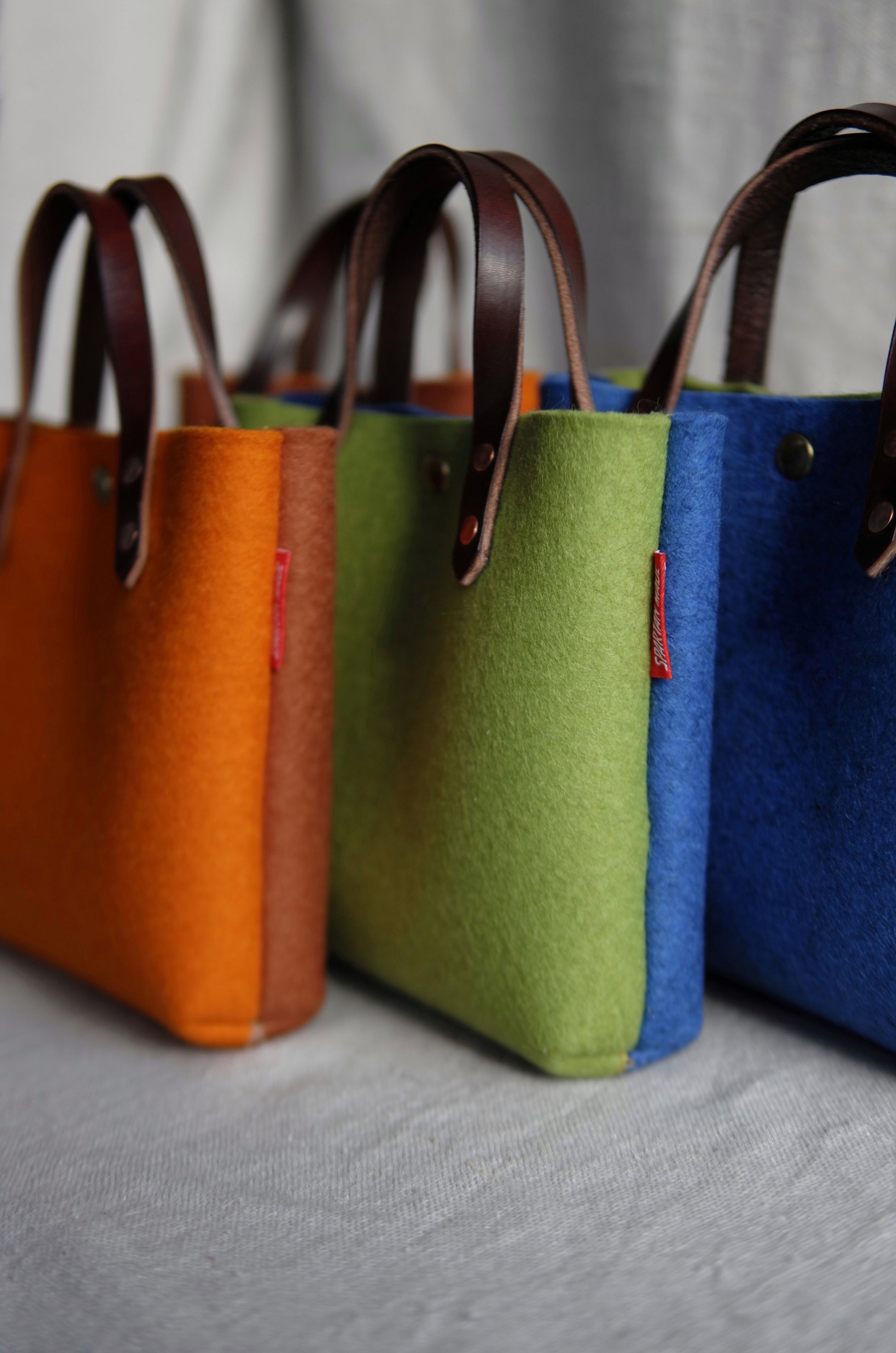 Two-tone felt mini tote bag by Spartan Made with lightweight design and sturdy handles, perfect for everyday use.