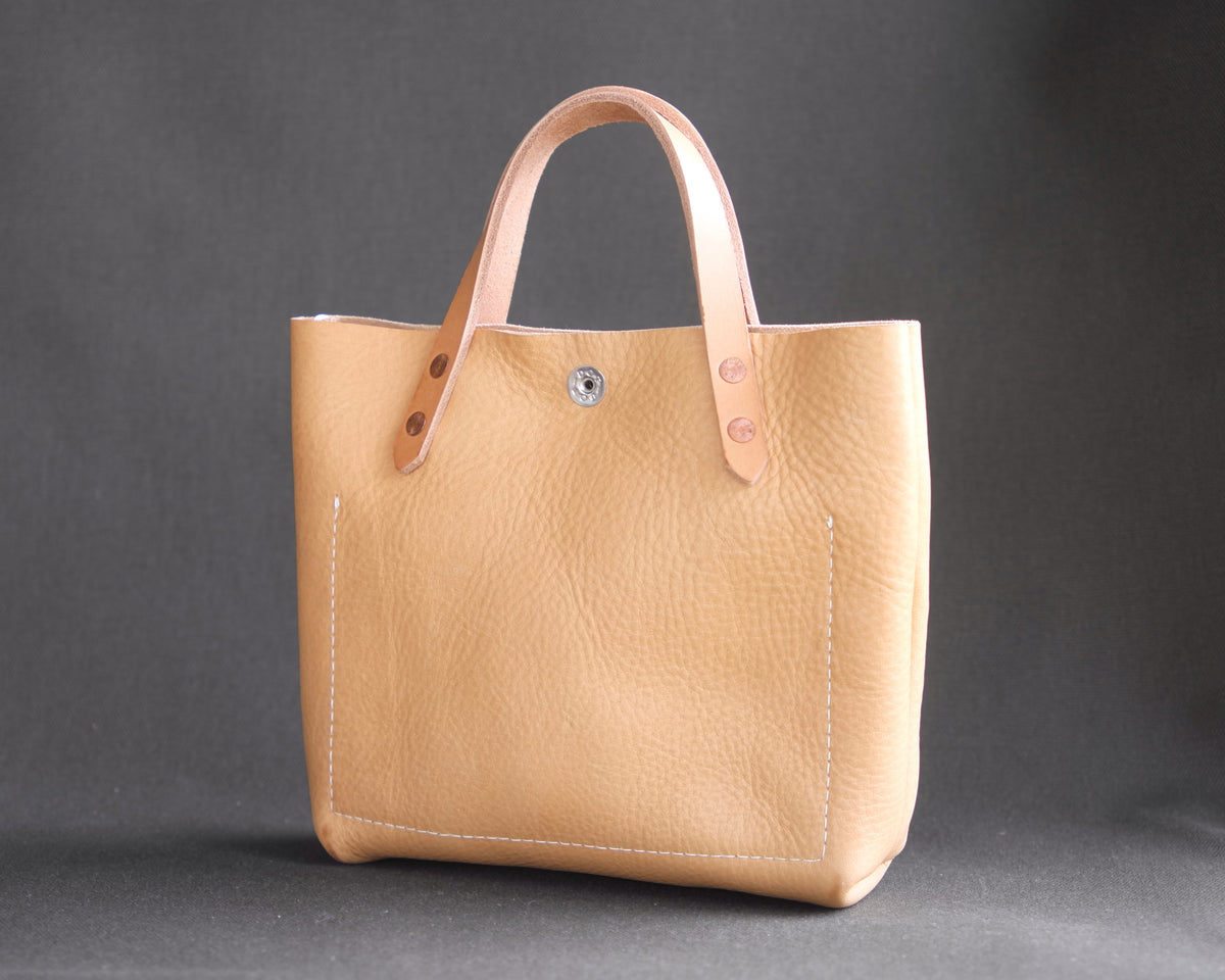 Spartan Made mini leather tote bag with natural leather finish, showing the back view with clean stitching and compact design.