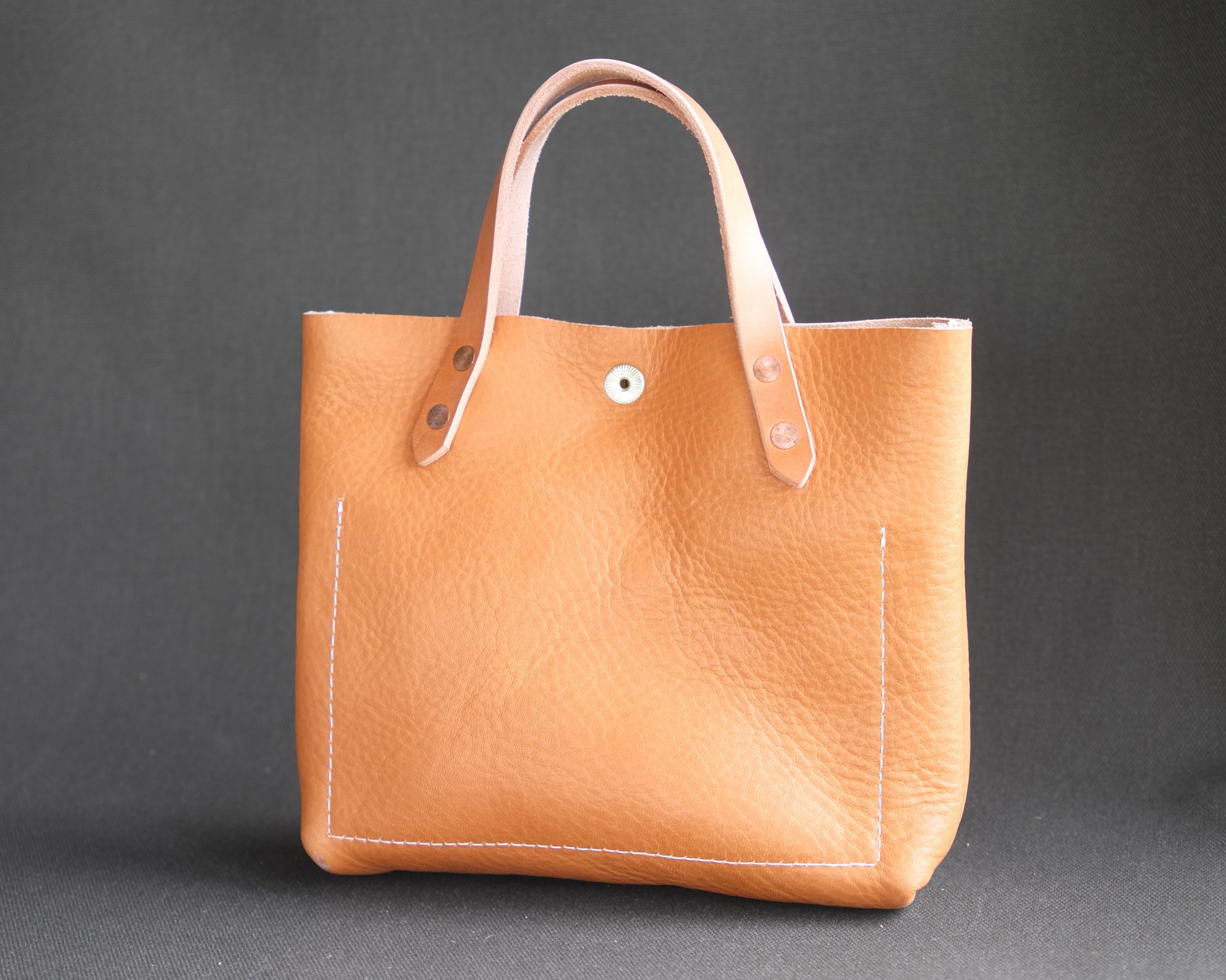 Spartan Made leather mini tote bag with natural leather finish, showing the back view with clean stitching and compact design