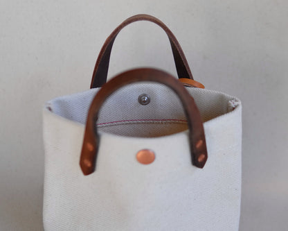 Close-up of Spartan Made mini canvas tote bag showing textured fabric, sturdy handles, and minimalist design details.