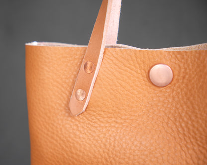 Spartan Made mini leather tote bag with natural finish, showing close-up detail of textured leather and sturdy handles.