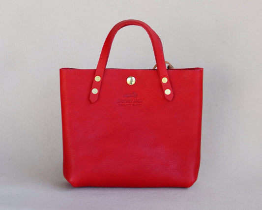 Red leather Spartan Made mini tote bag with sturdy handles and sleek design, perfect for everyday use.