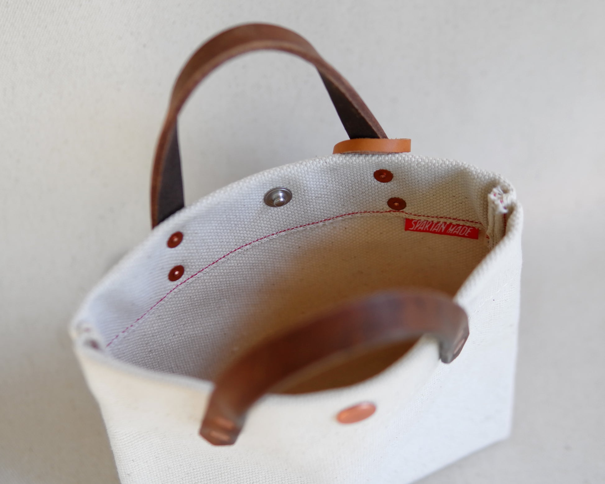 Spartan Made mini tote bag with canvas material, showing the interior design and spacious compartment.