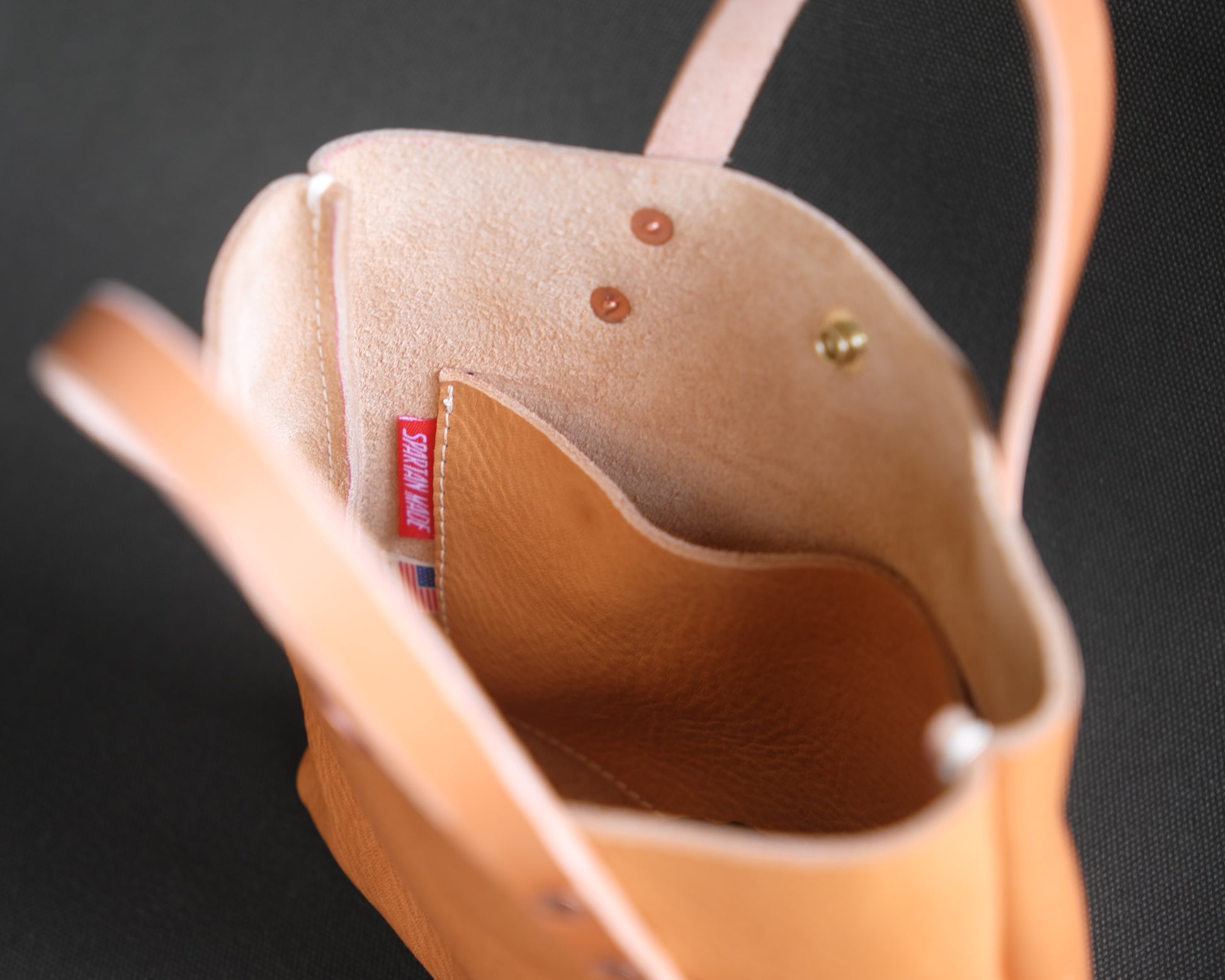 Spartan Made leather mini tote bag with natural interior lining, showing the spacious inside and sleek design.