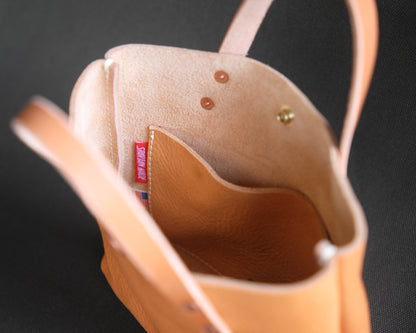 Spartan Made leather mini tote bag with natural interior lining, showing the spacious inside and sleek design.