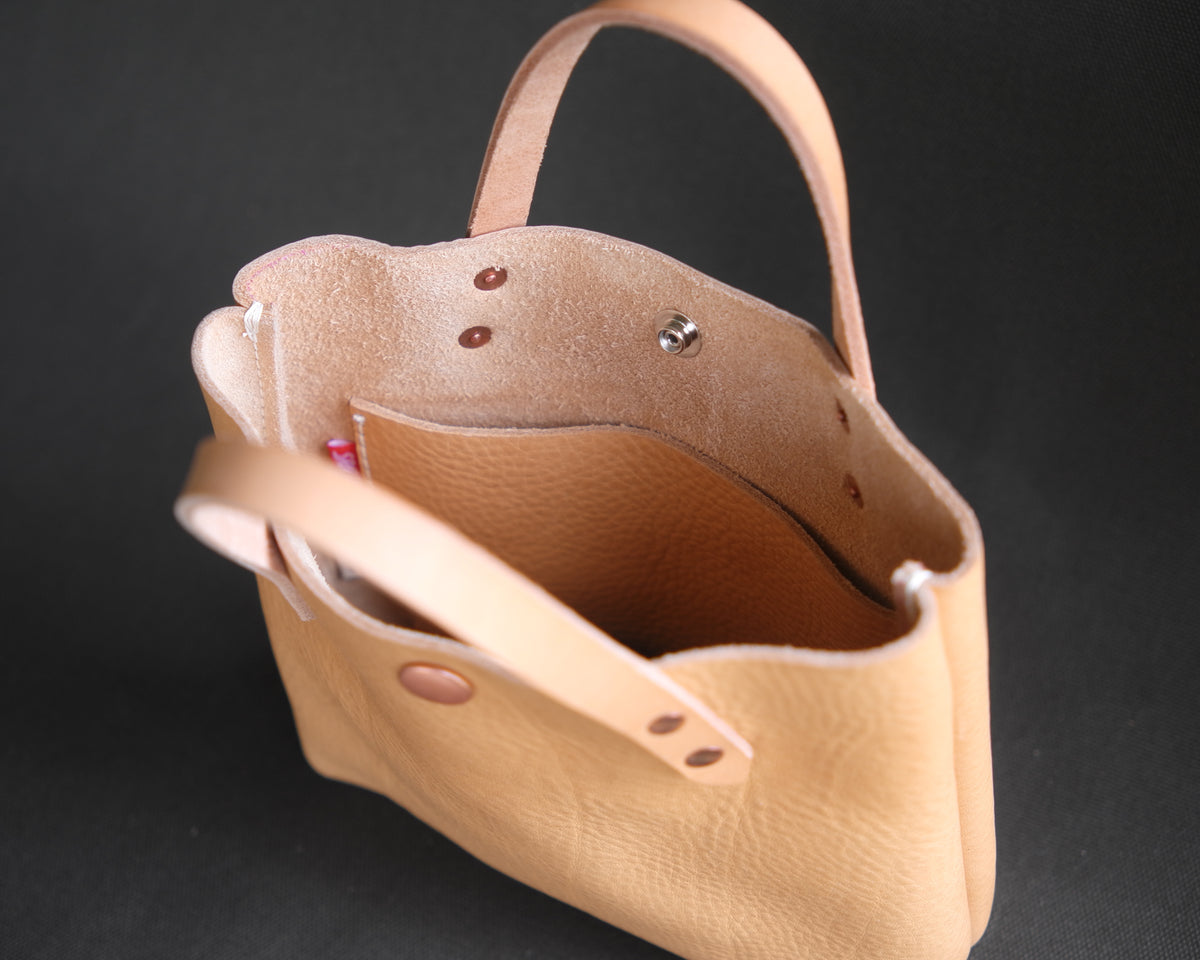 Spartan Made leather mini tote bag interior showing natural tan leather lining and spacious compartment.