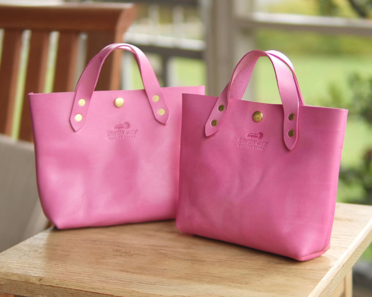 Pink leather mini tote bag from Spartan Made, showcasing a compact tote with stylish design and top handles.