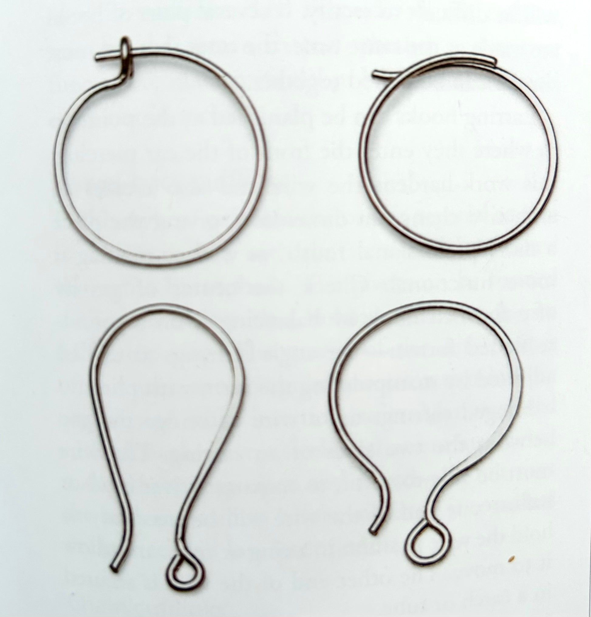 Pair of colorful Alloy Atelier Oops! All Earrings featuring mixed shapes and playful designs, displayed on a neutral background.