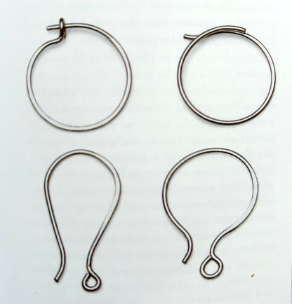 Pair of colorful Alloy Atelier Oops! All Earrings featuring mixed shapes and playful designs, displayed on a neutral background.
