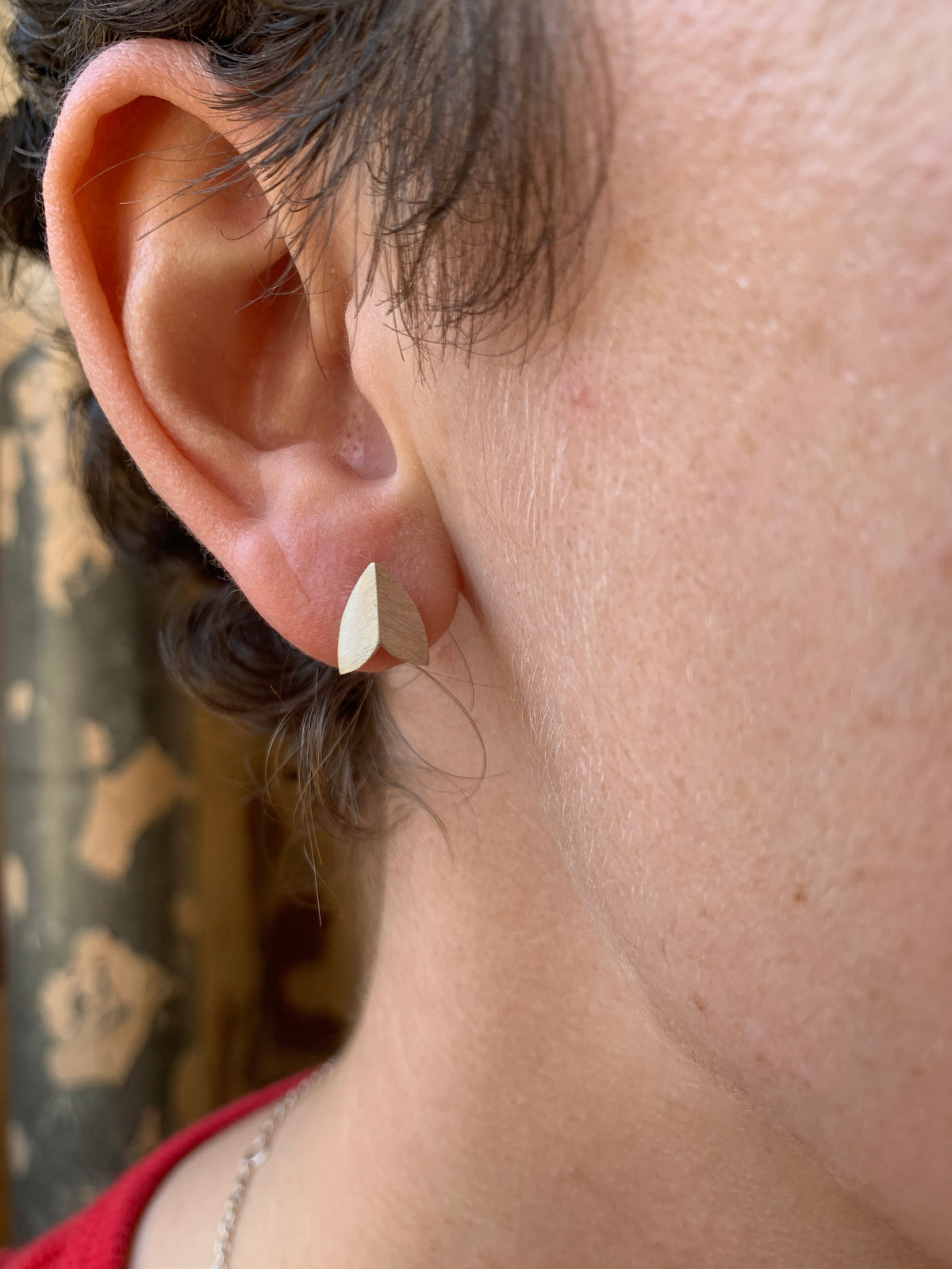 Silver moth wing stud earrings by Ellyse Bendillo featuring matte finish and detailed wing design.