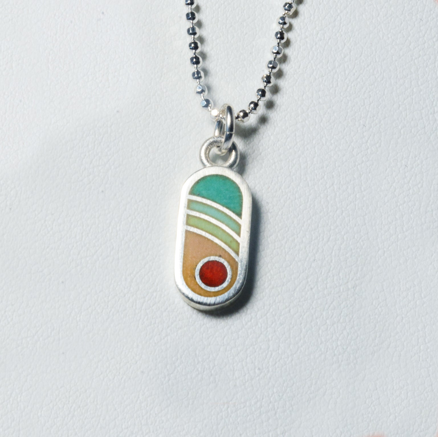 Echo Metals Sunny Charm necklace featuring a small, radiant sun pendant on a delicate chain.