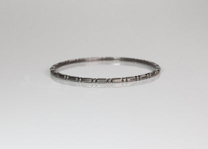 Oxidized silver Orbit bangle by The Tiny Jeweler featuring a sleek, modern design with a smooth, polished surface.
