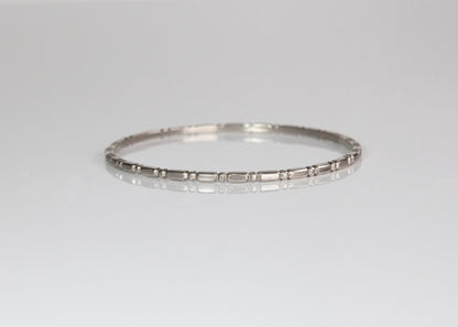 Silver Orbit Bangle by The Tiny Jeweler, sleek and minimalist jewelry accessory displayed flat on a neutral background.
