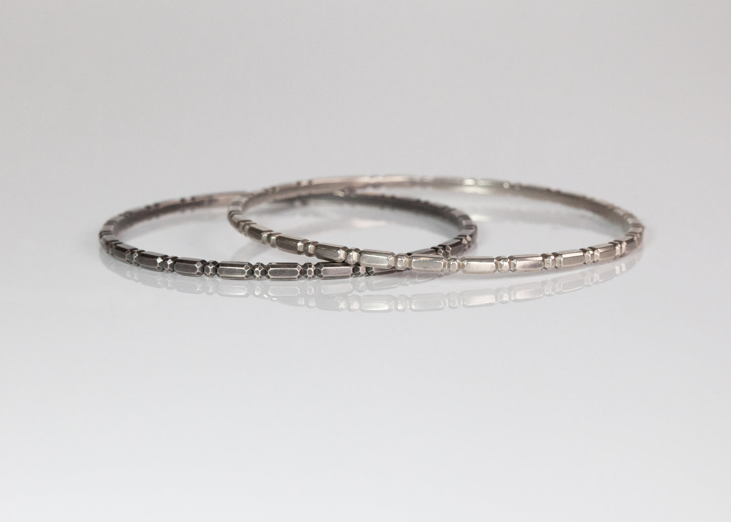 Set of three gold Orbit bangles by The Tiny Jeweler, featuring smooth, rounded designs stacked together.