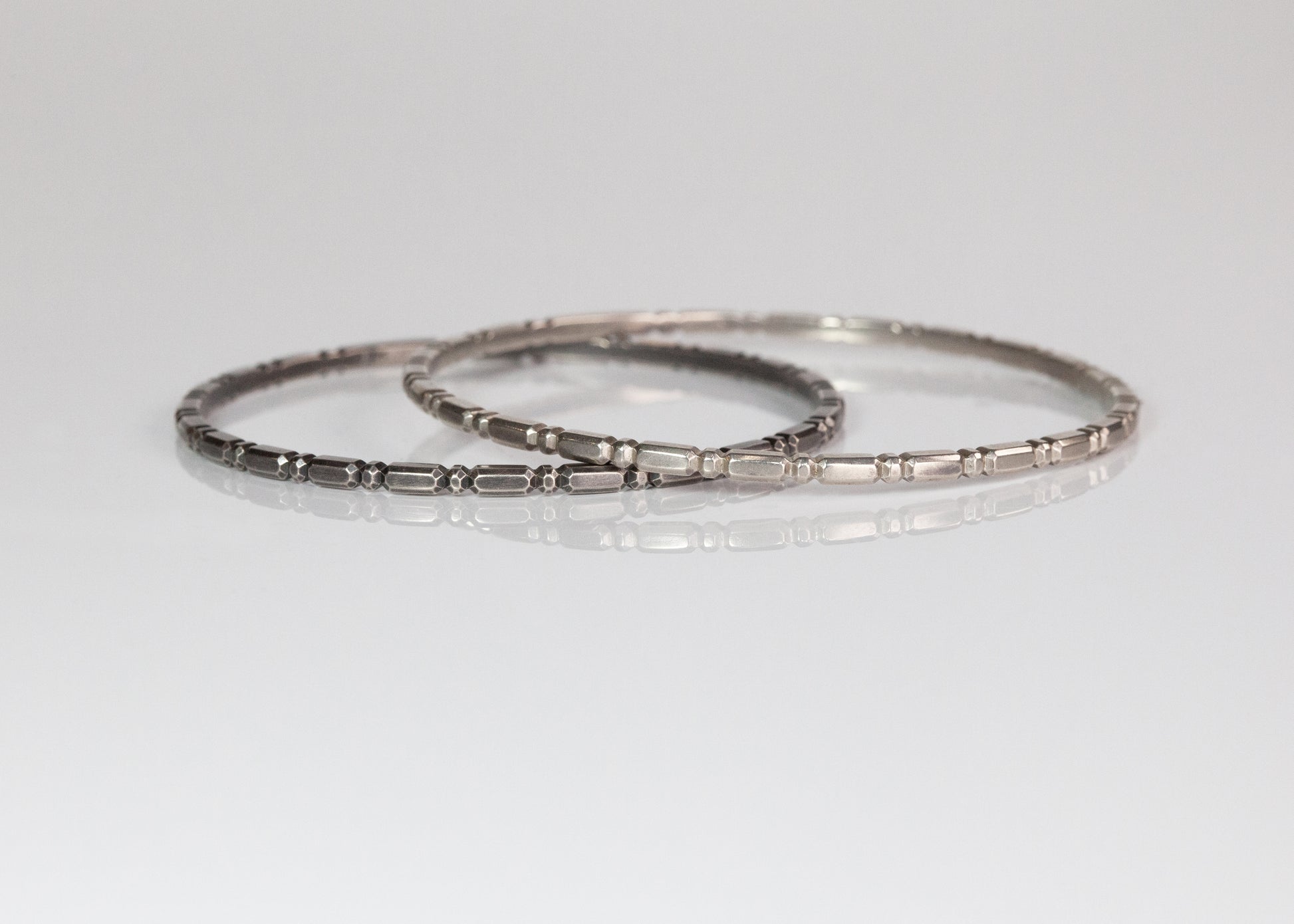 Set of three gold Orbit bangles by The Tiny Jeweler, featuring smooth, rounded designs stacked together.