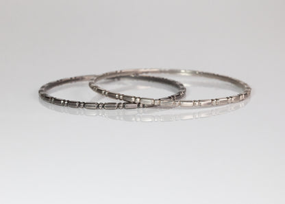 Set of three gold Orbit bangles by The Tiny Jeweler, featuring smooth, rounded designs stacked together.