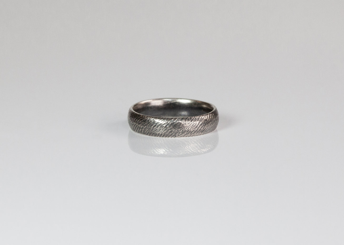 Textured band ring by The Tiny Jeweler, 5mm width, featuring a matte, hammered surface and sleek design.