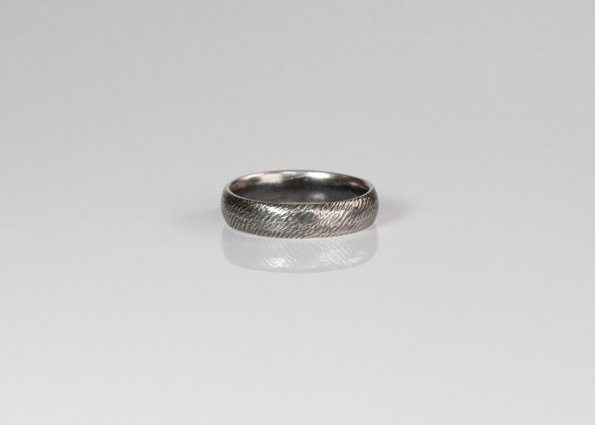 Textured band ring by The Tiny Jeweler, 5mm width, featuring a matte, hammered surface and sleek design.