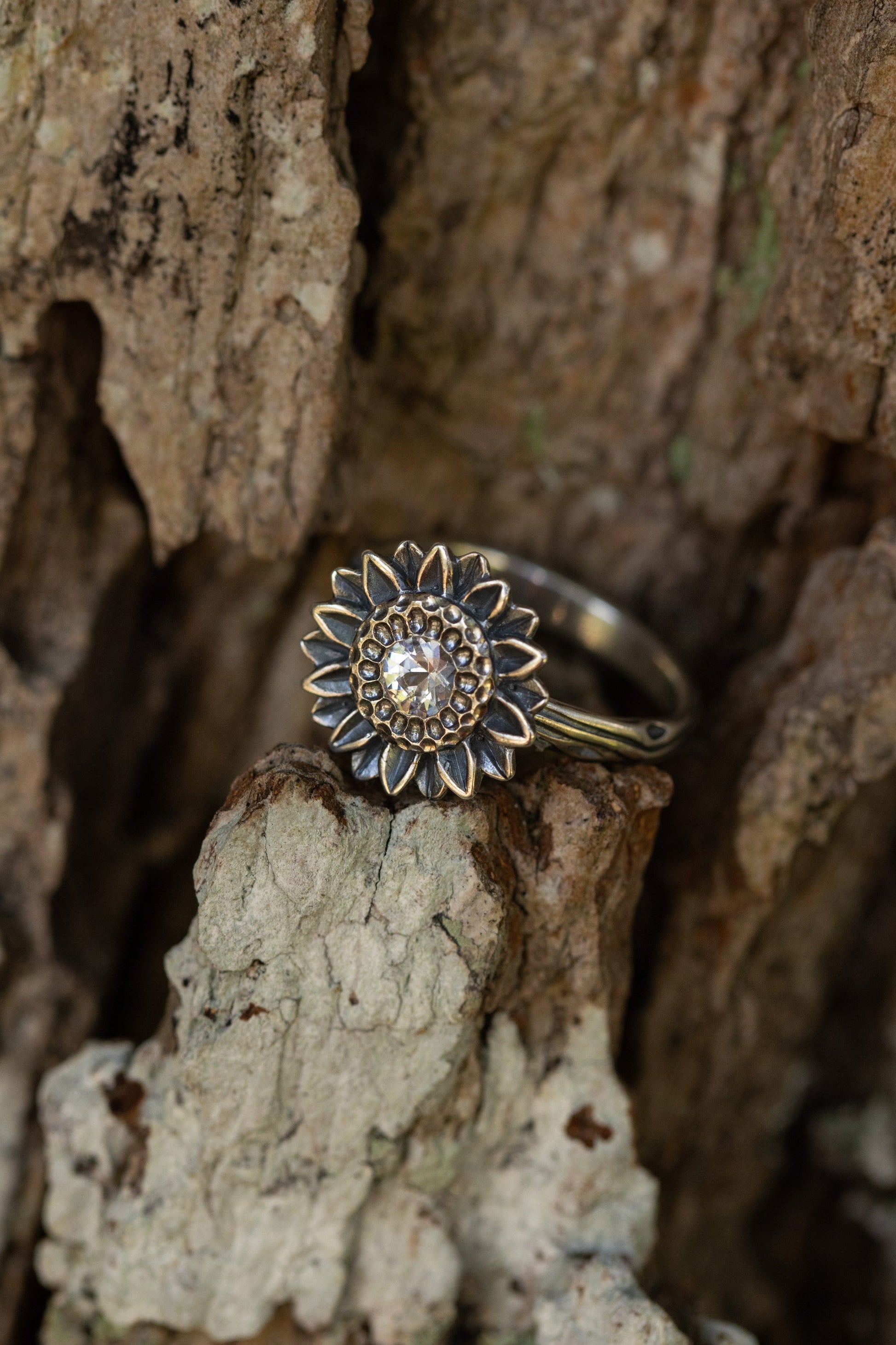 Solitaire sunflower ring by The Tiny Jeweler featuring a detailed sunflower design on a gold band.