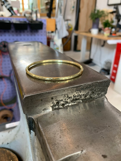 Silver bangle bracelet from Alloy Atelier featuring a sleek, minimalist design with smooth, polished surface for elegant wear.