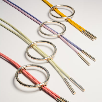 Echo Metals bolo tie with intricate silver design and leather cord, featuring a decorative metal slide.