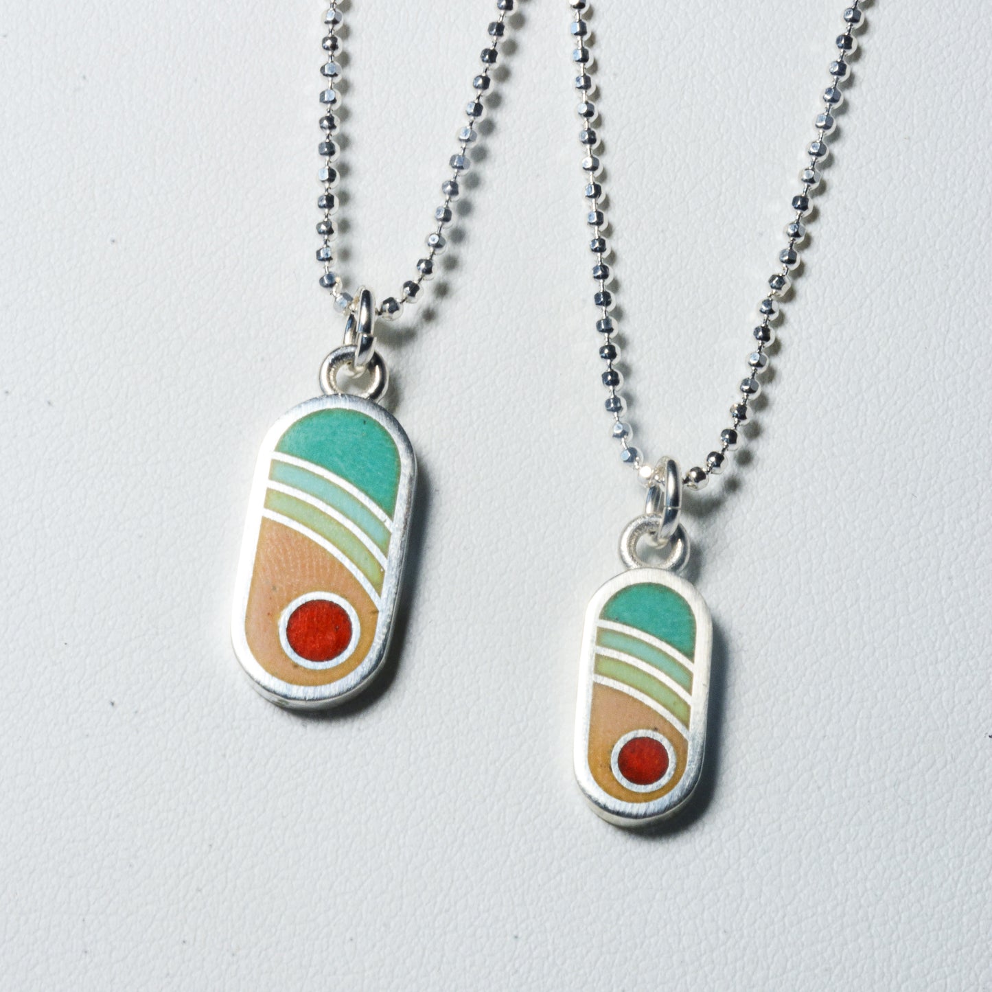 Echo Metals Sunny Charm necklace featuring a simple, elegant gold-toned charm pendant on a delicate chain.
