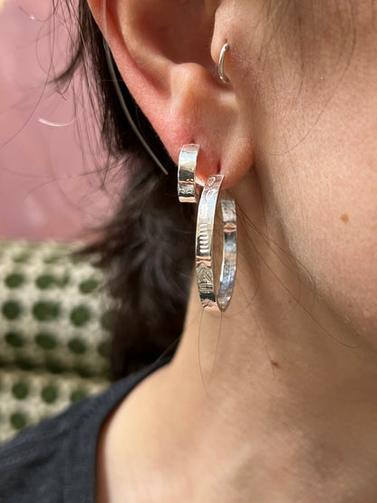Alloy Atelier Hoop Earrings featuring sleek, silver hoops with a polished finish, stylish jewelry accessory for everyday wear