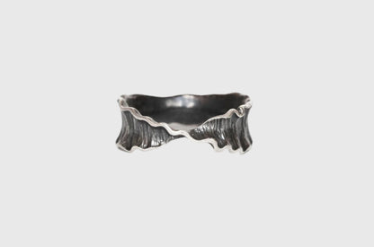 Silver orchid ring from Alloy Atelier's Intro to Carving & Casting class, featuring a detailed floral design on a sleek band.